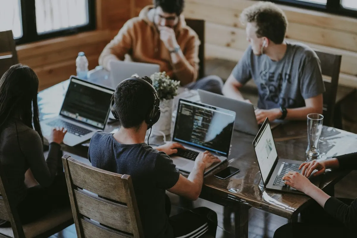 Illustrative photograph of colleagues sharing ideas in a workplace
